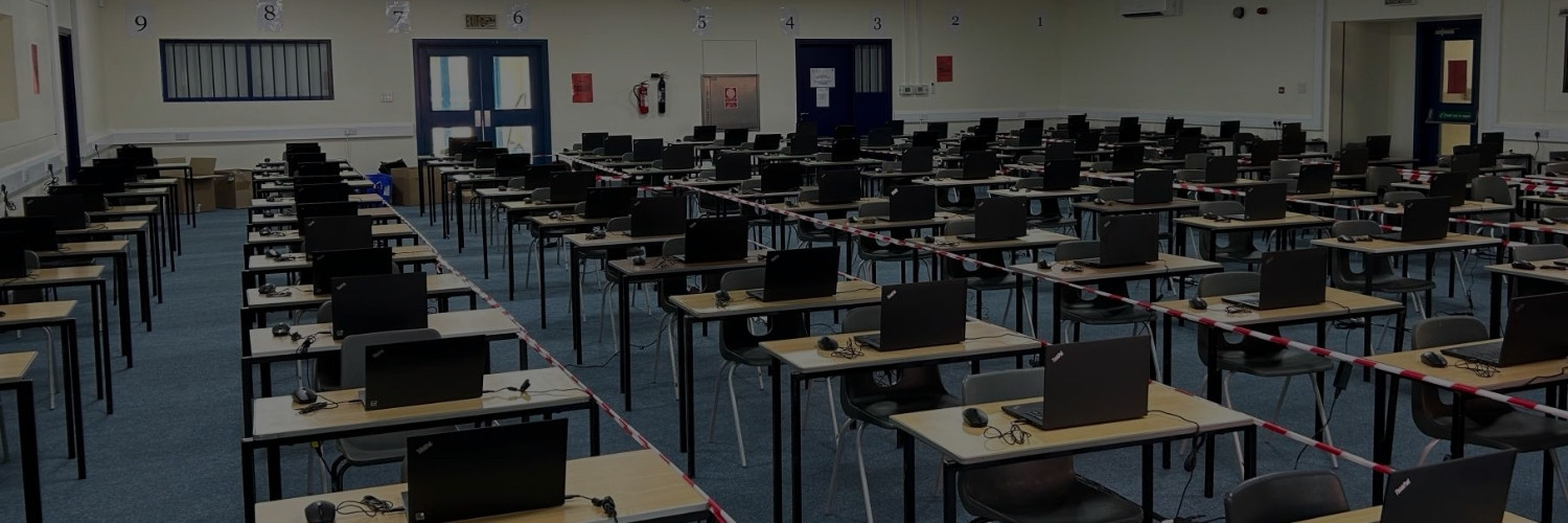Exam center setup with laptops for digital exams
