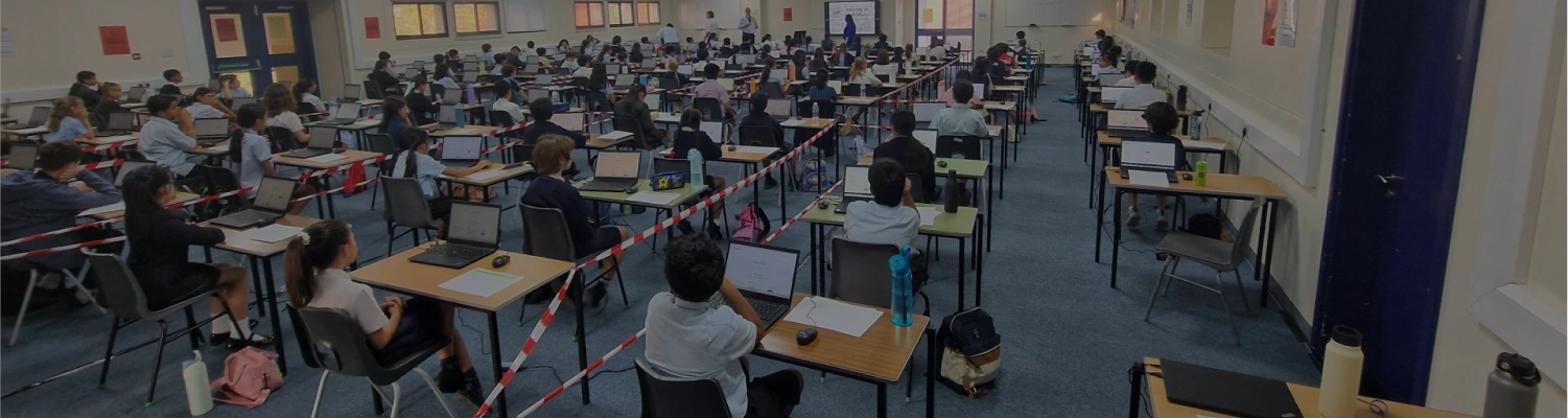 Exam center setup with laptops for digital exams